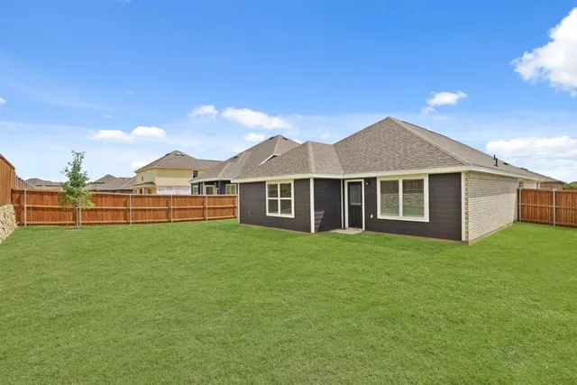 a view of a yard with a house in the background