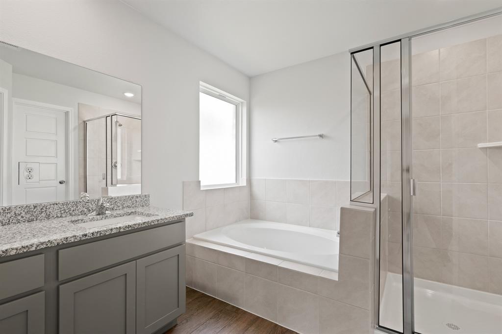 3117 Harmony Way Cleburne, TX 76031 - Photo 10 of 20 a bathroom with a granite countertop tub sink and mirror