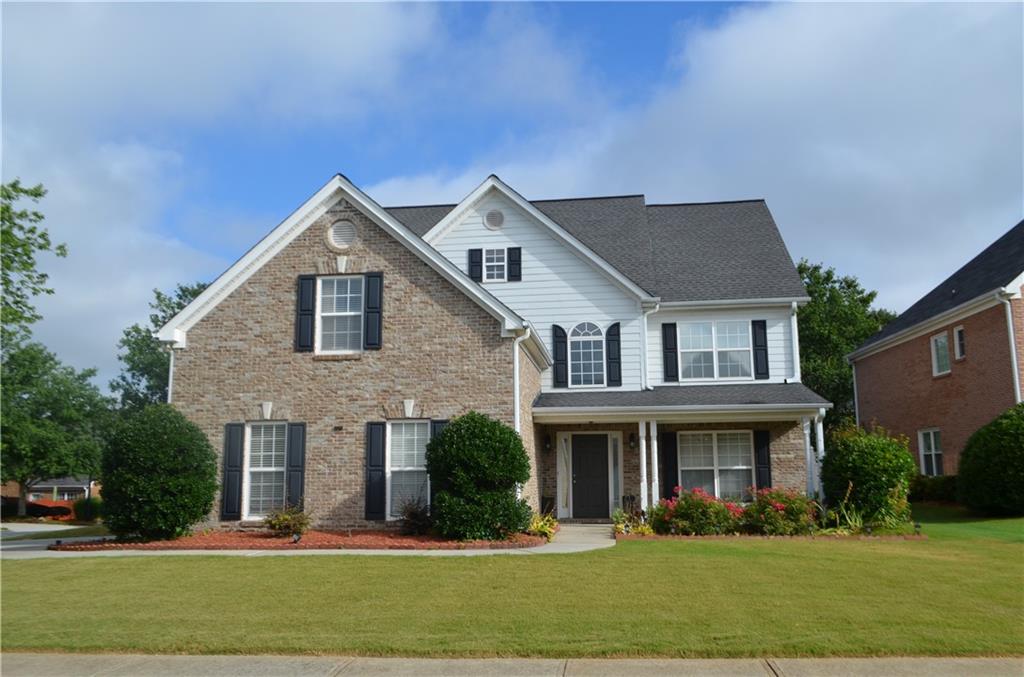 a front view of a house with a yard