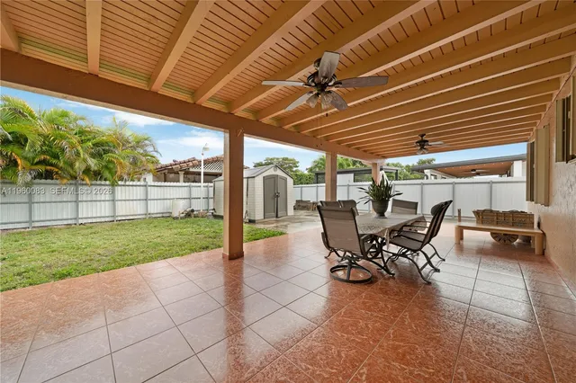 a view of a patio with table and chairs and potted plants