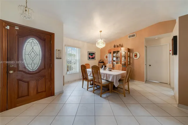 a view of a dining area with furniture and a large window