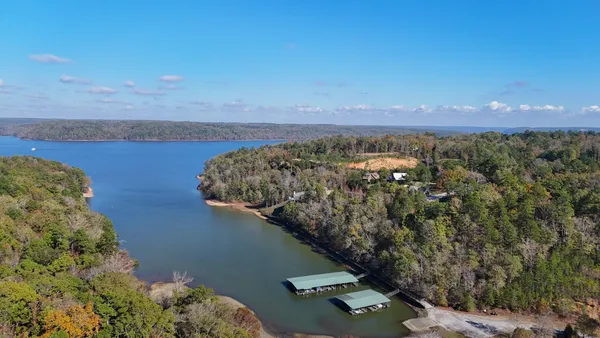 an aerial view of a residential houses with outdoor space