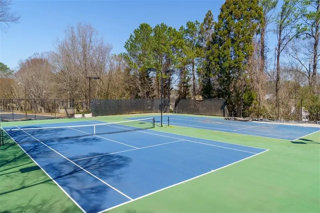 a view of a house with a big yard and large trees