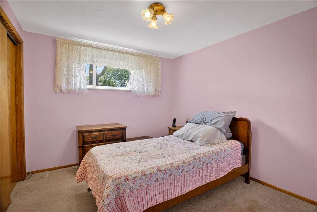 186 William Street McKees Rocks, PA 15136 - Photo 20 of 45 a bedroom with a bed and a chandelier