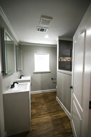 a room with a sink and mirror