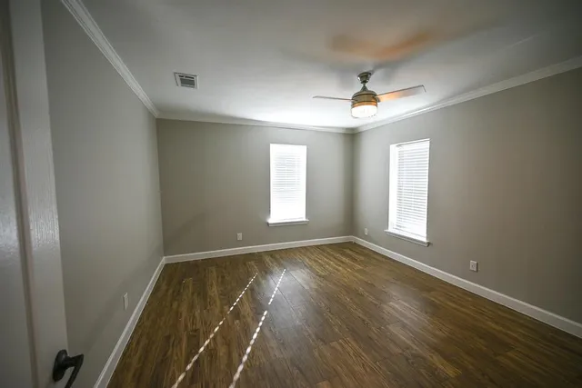 wooden floor in an empty room with a window