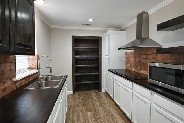 a kitchen with granite countertop a sink stainless steel appliances a counter space and cabinets