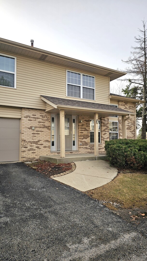 9310 Meadowview Drive Orland Hills, IL 60487 - Photo 1 of 23 a front view of a house with yard and garage