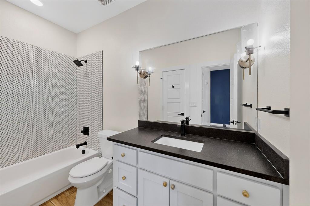 800 South Welch Street, Unit 208 Denton, TX 76201 - Photo 8 of 15 a bathroom with a double vanity sink toilet and shower