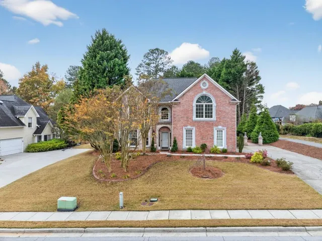 a front view of a house with a yard