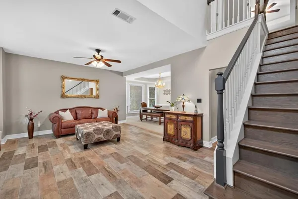 a kitchen with stainless steel appliances a stove a sink and white cabinets