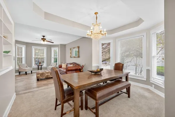 a kitchen with white cabinets a sink a stove and a refrigerator