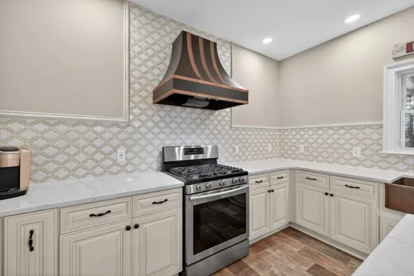 a kitchen with cabinets and stainless steel appliances