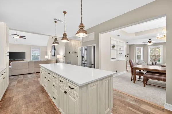 a living room with furniture ceiling fan and a wooden floor