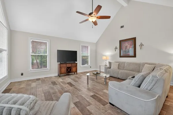a view of a hallway with windows and entryway