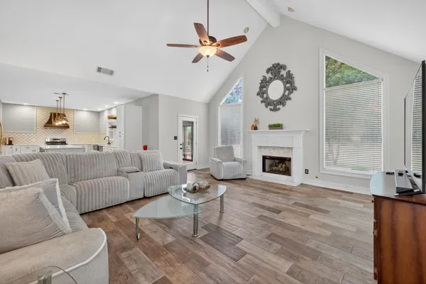 a living room with furniture and a chandelier
