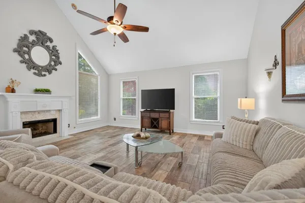 a bedroom with a bed a fireplace and a chandelier