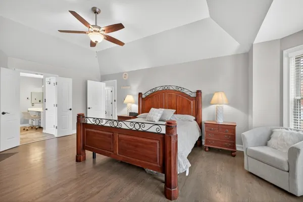 a bedroom with a bed and a chandelier