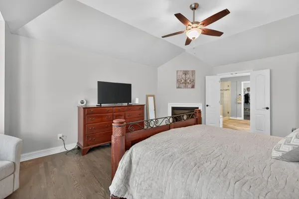 a bedroom with a bed and a chandelier