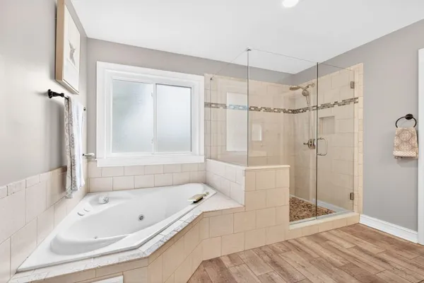 a bedroom with a large bed and a window