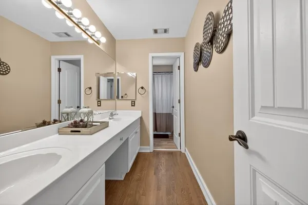a view of a backyard with table and chairs and potted plants