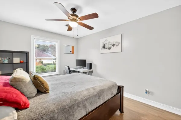 a living room with furniture and a large window with wooden floor