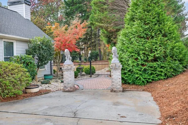 a view of a white house with a yard