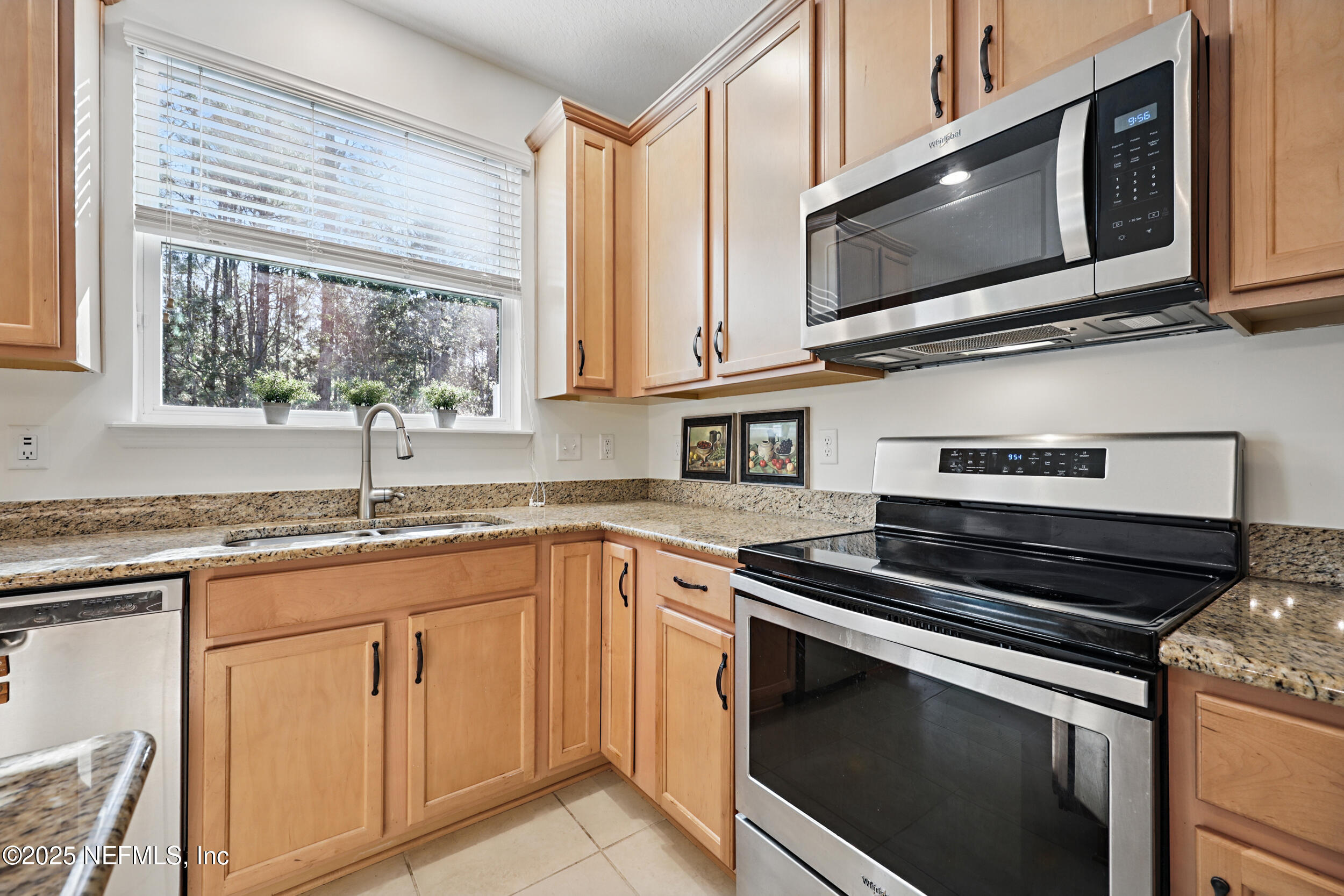 63 Via Sonrisa St. Augustine, FL 32092 - Photo 16 of 48 a kitchen with granite countertop white cabinets appliances a window and a sink