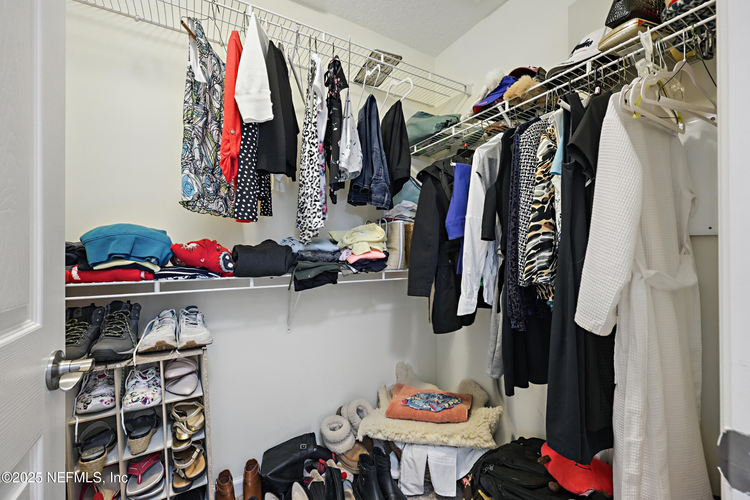 63 Via Sonrisa St. Augustine, FL 32092 - Photo 29 of 48 a view of walk in closet with clothes and shoes