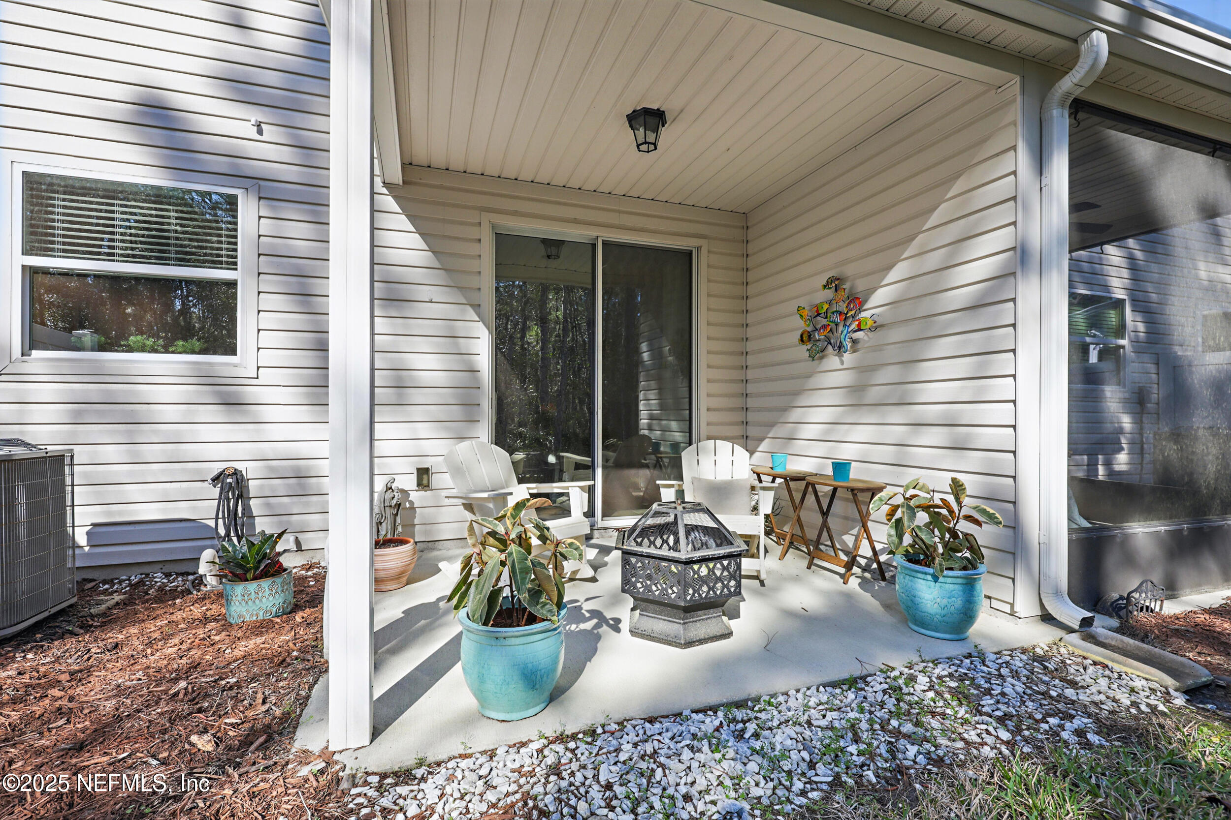 63 Via Sonrisa St. Augustine, FL 32092 - Photo 37 of 48 a view of a patio with couple of chairs and potted plants