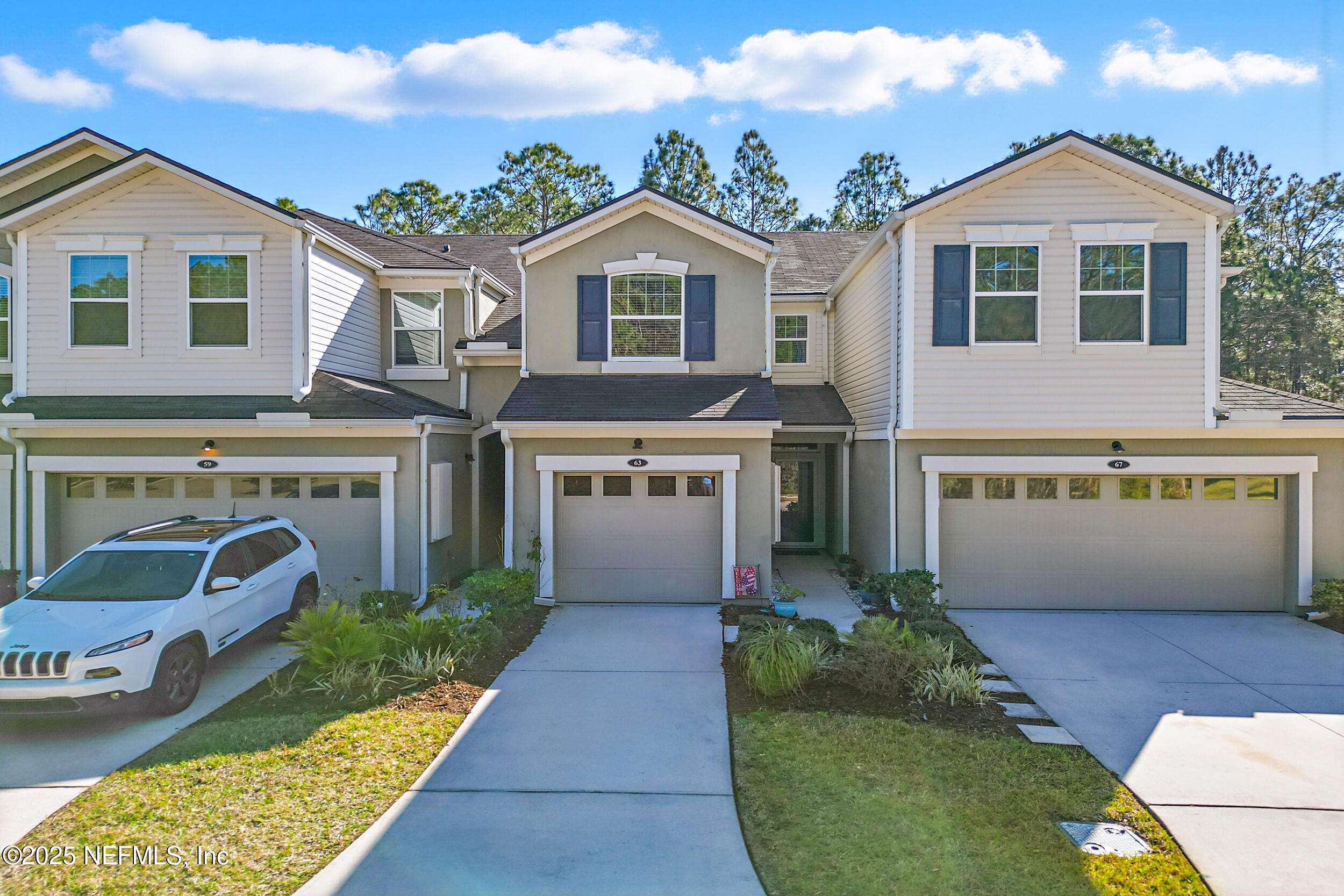 63 Via Sonrisa St. Augustine, FL 32092 - Photo 39 of 48 a front view of a house with a yard and garage
