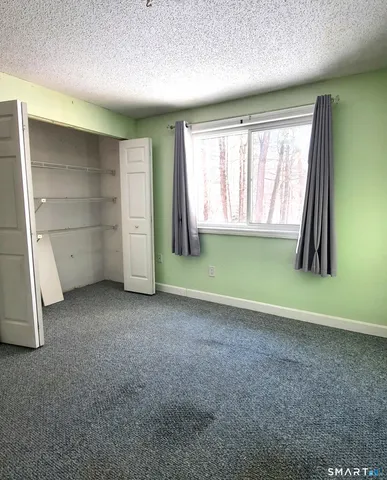 an empty room with a fireplace and painted walls