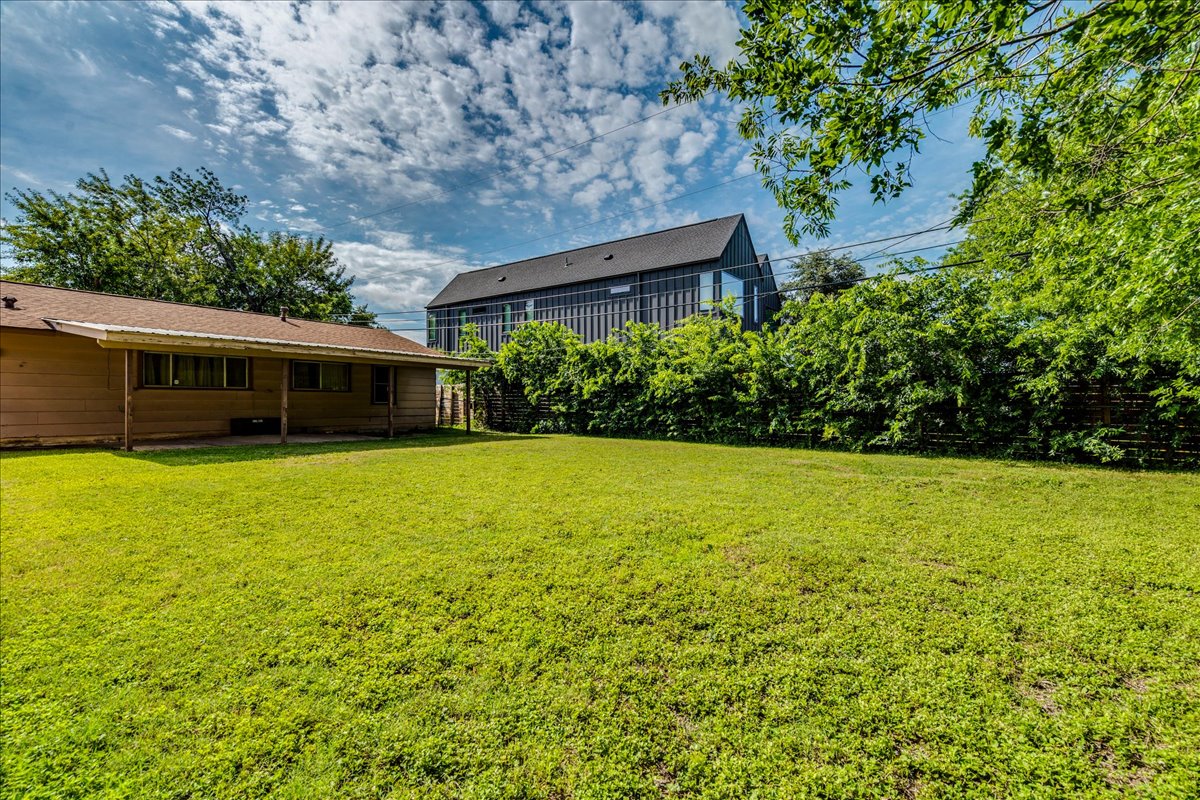 6626 Isabelle Drive Austin, TX 78752 - Photo 26 of 27 Expansive green lawn with mature perimeter foliage