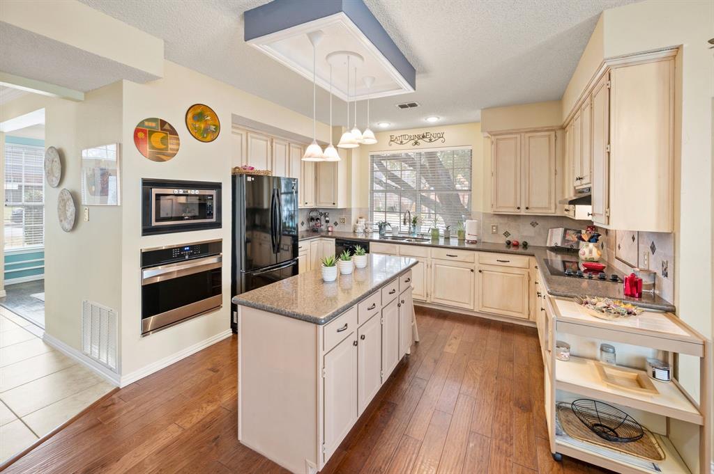 2156 Sandell Drive Grapevine, TX 76051 - Photo 15 of 40 a open kitchen with stainless steel appliances granite countertop a stove and a sink