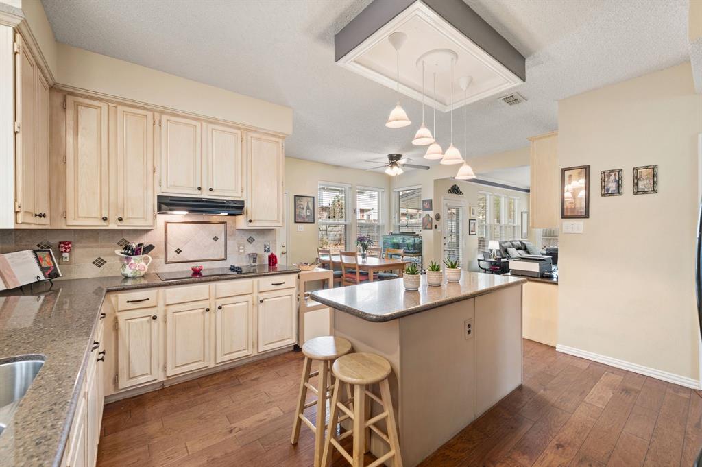 2156 Sandell Drive Grapevine, TX 76051 - Photo 19 of 40 a kitchen with center island cabinets and stainless steel appliances