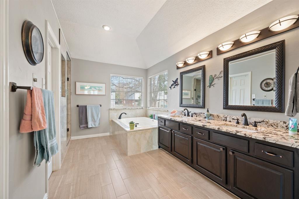 2156 Sandell Drive Grapevine, TX 76051 - Photo 25 of 40 a spacious bathroom with a granite countertop sink and a mirror