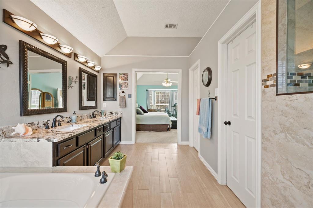 2156 Sandell Drive Grapevine, TX 76051 - Photo 27 of 40 a spacious bathroom with a double vanity sink a mirror and a shower