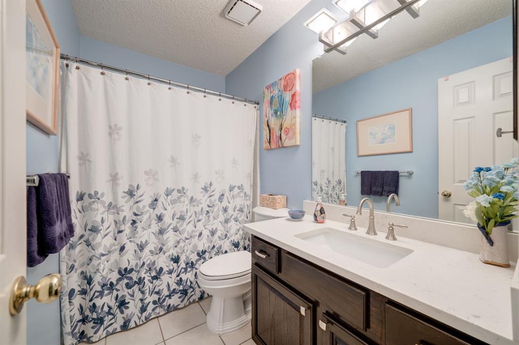 2156 Sandell Drive Grapevine, TX 76051 - Photo 29 of 40 a bathroom with a sink toilet and shower