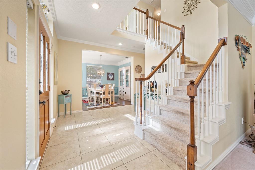 2156 Sandell Drive Grapevine, TX 76051 - Photo 4 of 40 a view of a hallway with wooden floor and staircase