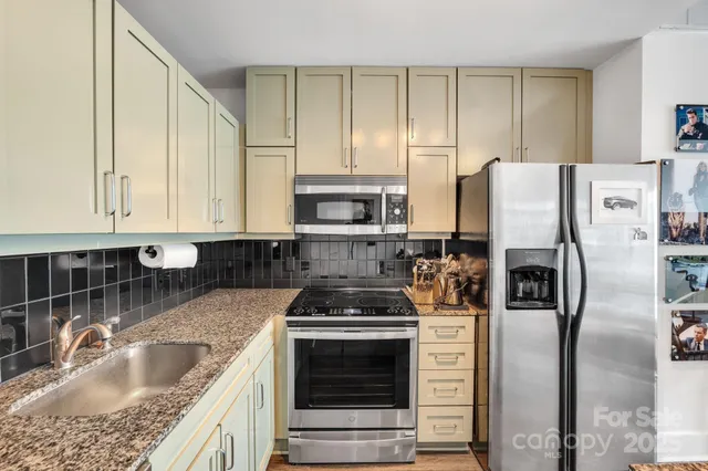 a kitchen with a table chairs and refrigerator