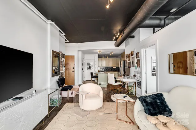 a bedroom with a bed and large windows