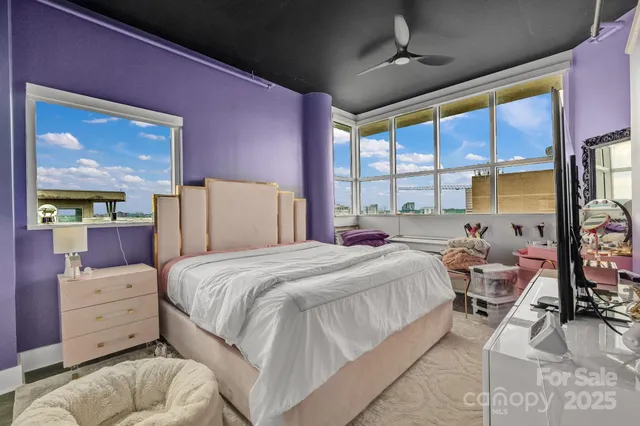 a en suite bathroom with a granite countertop sink and a mirror