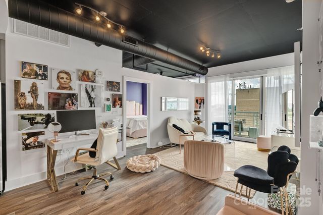 a view of a workspace with lots of stuff and hardwood floor