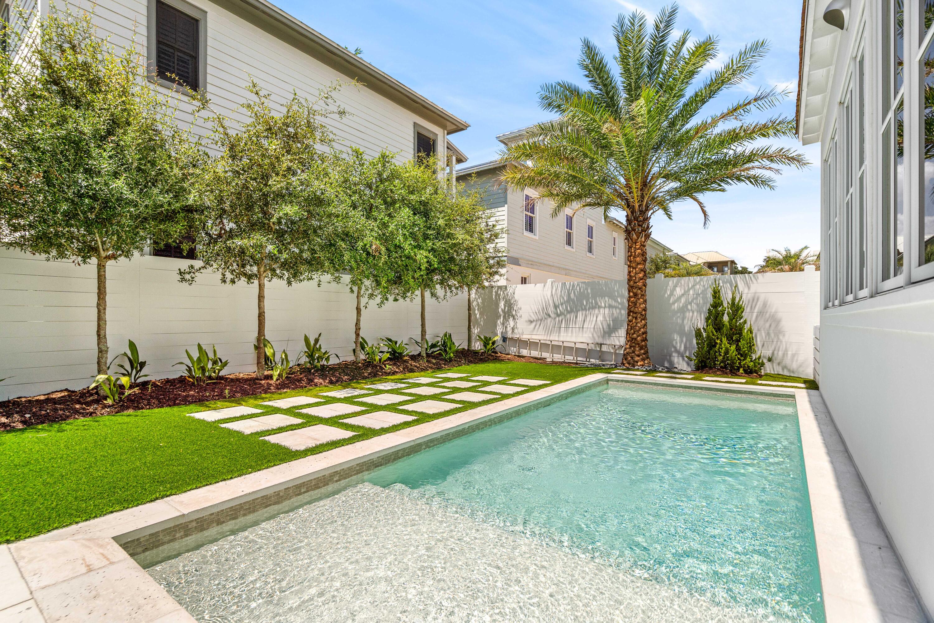 74 Elysee Ct Inlet Beach Inlet Beach, FL 32461 - Photo 3 of 46 a view of a backyard with plants and palm trees
