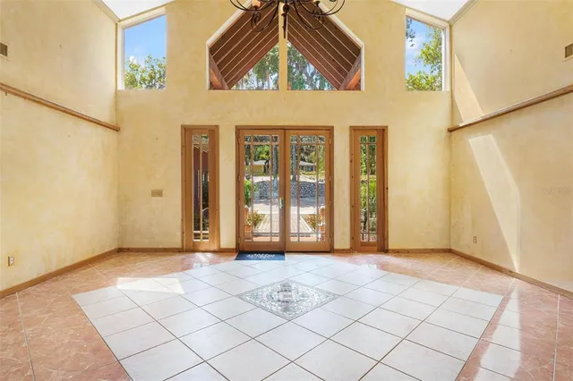a living room with furniture kitchen view and a large window