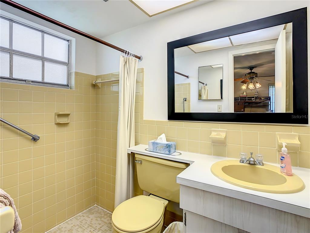 4230 Redcliff Place, Unit 4230 New Port Richey, FL 34652 - Photo 16 of 42 a bathroom with a toilet a sink and mirror