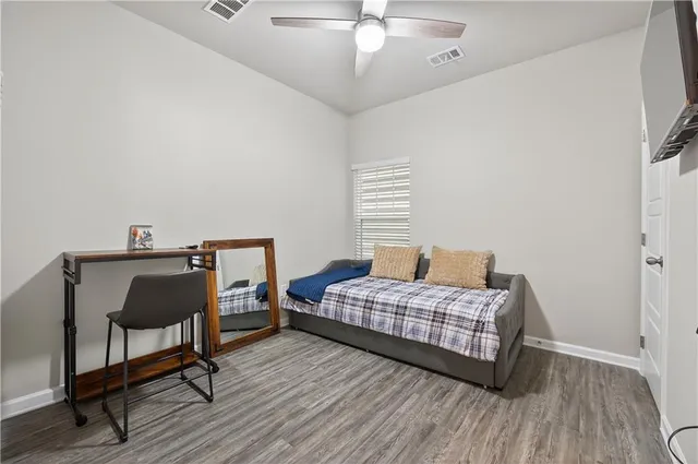 a bedroom with a bed and a chair