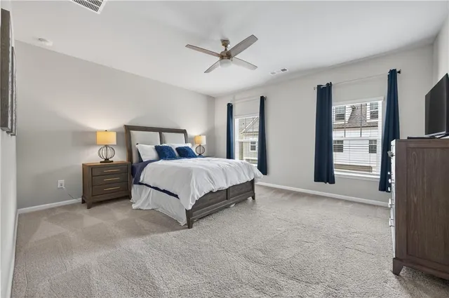 a bedroom with a bed and ceiling fan