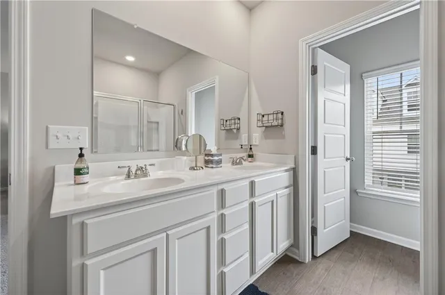 a bathroom with a double vanity sink and mirror