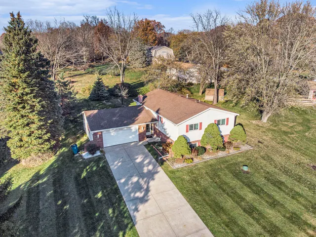 an aerial view of a house with a yard